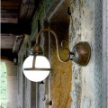 Designer brass and glass wall sconce Cimosa